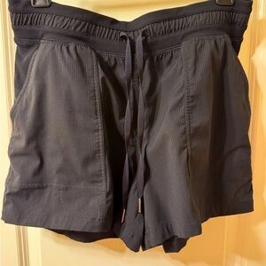 Calling all LuLu fans! Lululemon Women's Shorts in black, size 8, nylon fabric.